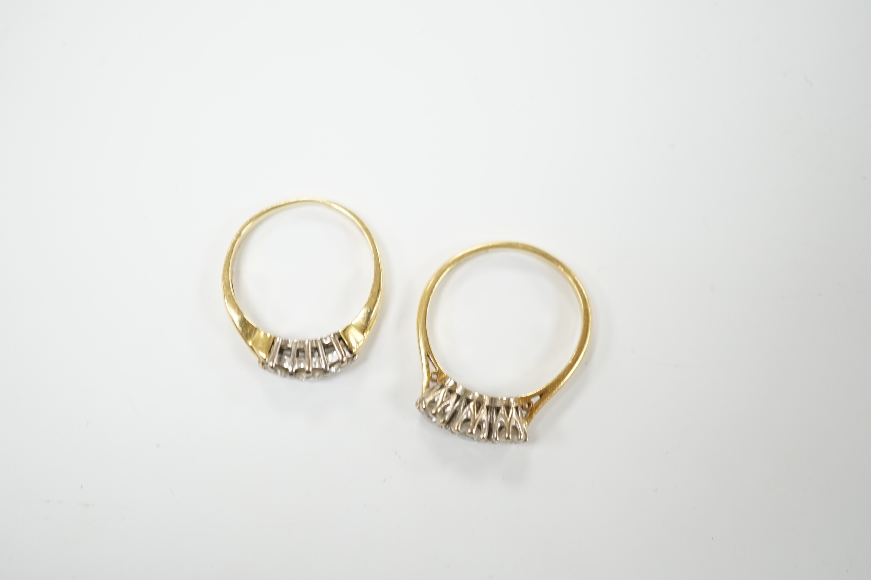 An 18ct gold three stone diamond ring, size M, and a similar ring of larger size, size P, gross 6.2 grams